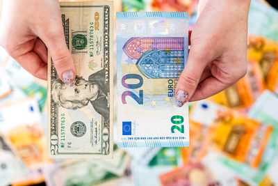 Cropped hand of person holding paper currency