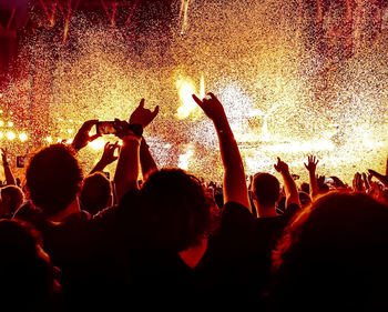 Cheering young people at a rock concert