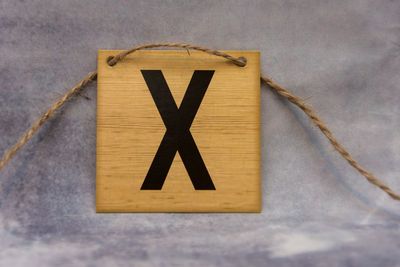 Close-up of road sign against sky