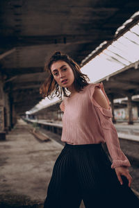 Portrait of young woman standing outdoors