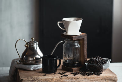 Close-up of coffee maker on table against wall