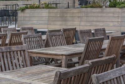 Empty wooden chairs and table at outdoor cafe