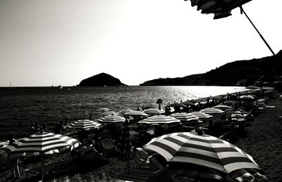 People on beach against clear sky