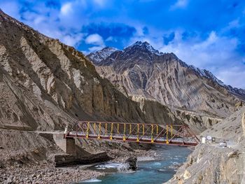 Scenic view of bridge over mountain against sky