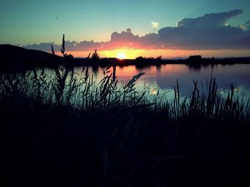 Scenic view of lake at sunset