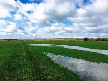 Countryside landscape against cloudy sky