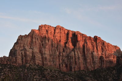 Low angle view of rocky mountains against sky