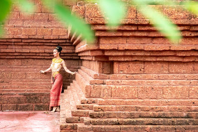 Rear view of woman standing on staircase