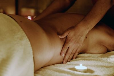 Cropped image of therapist massaging woman at spa