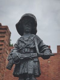 Low angle view of statue against sky