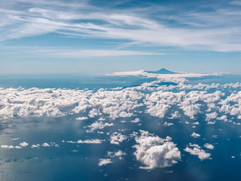 Aerial view of sea and volcano against sky