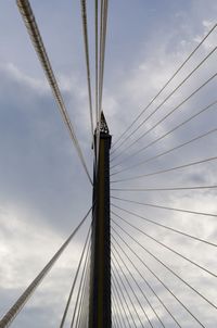 Low angle view of suspension bridge against sky