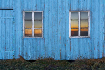 Abandoned house and sunrise in the windows