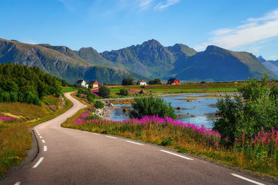 Road by mountain against sky