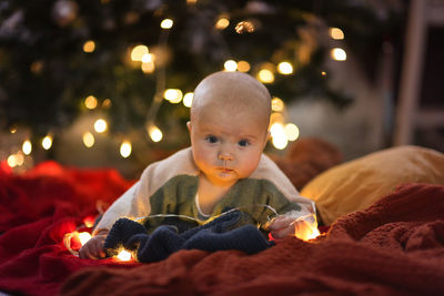 Close-up of cute boy looking away at home