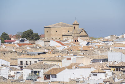 Buildings in town against clear sky