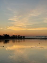 Scenic view of lake against sky during sunset