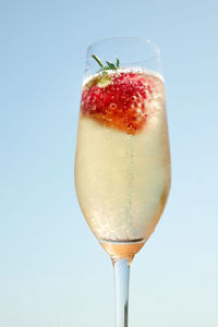 Close-up of drink on glass against white background