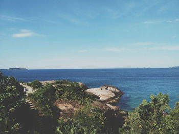 High angle view of rocky sea shore against sky