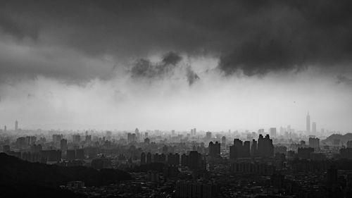 Aerial view of cityscape during storm clouds