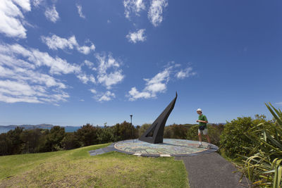 Statue on landscape against sky