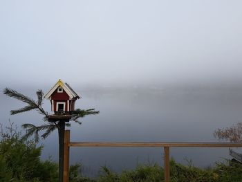 View of wooden post against sky during winter