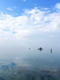 Scenic view of sea against cloudy sky