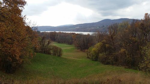 Scenic view of mountains against cloudy sky