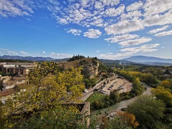 Panoramic view of trees and buildings against sky