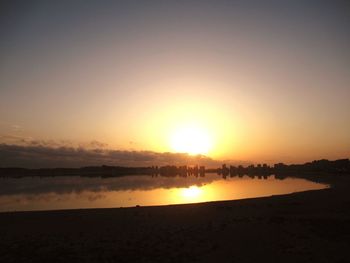 Scenic view of beach against sky during sunset
