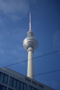 Low angle view of communications tower in city against sky in berlin