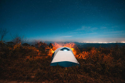 Tent on field against sky at night