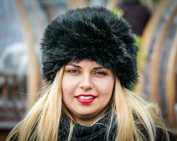 Close-up portrait of young woman in fur hat