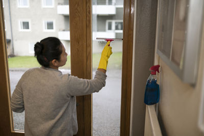 Woman cleaning window