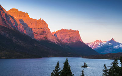 Scenic view of lake by mountains against sky