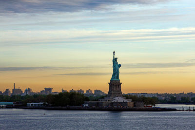 Statue of liberty against sky in city