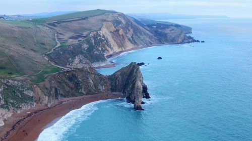 High angle view of sea and mountains against sky