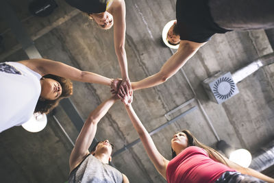 Group of young people huddling in gym