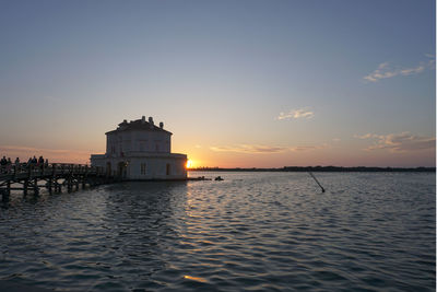 Scenic view of lake against sky during sunset