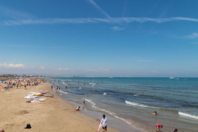 People on beach against sky