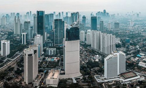 High angle view of modern buildings in city against sky