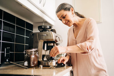 Young woman with coffee cup at home