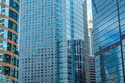 Low angle view of modern glass building in city