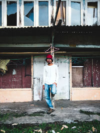 Full length of man standing outside building