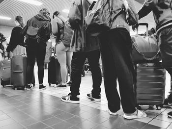 Group of people walking on tiled floor in city