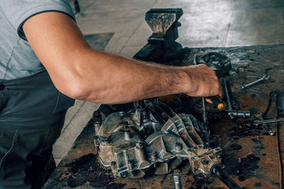 Midsection of man working at workshop