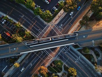 Directly above shot of train on railway bridge over roads in city