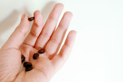 Close-up of human hand over white background