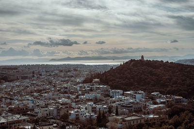 High angle view of townscape by sea against sky