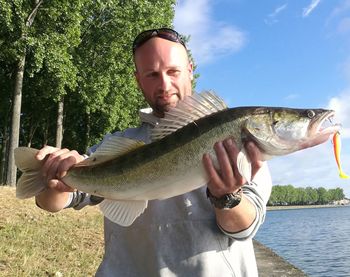 Mature man holding fish